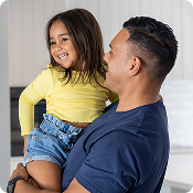 Smiling father holding his young daughter